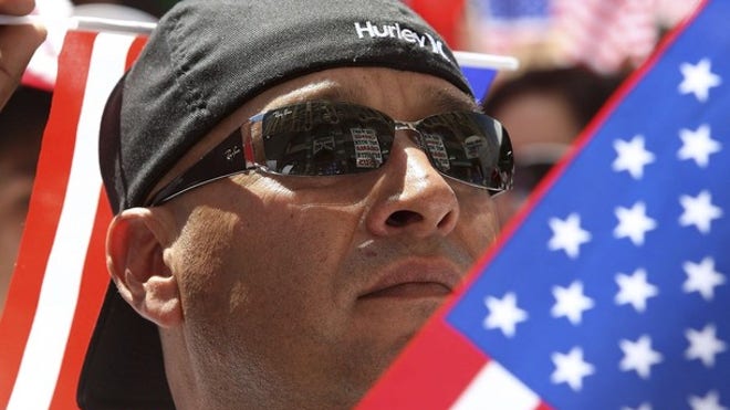 immigrant carrying flag_050110